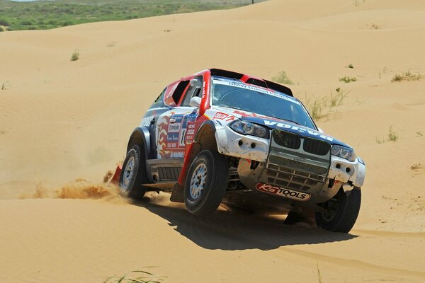 BMW X5 racing on sandy slopes