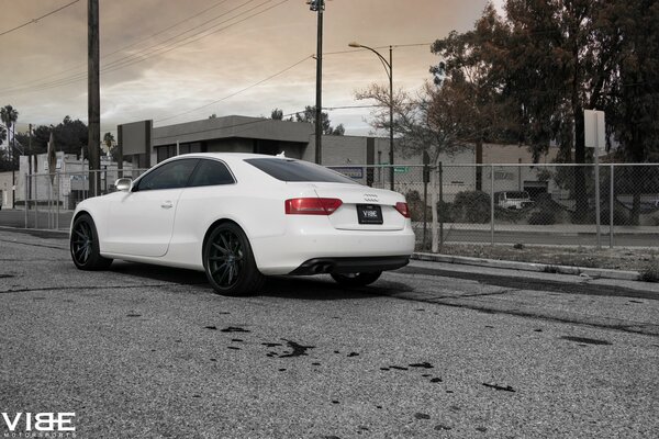 A white Audi stands with black discs