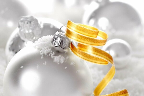 White Christmas balls with yellow ribbon