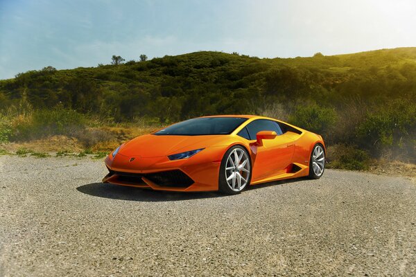 Orange expensive car parked on the road