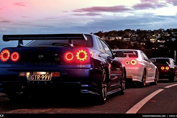 Nissan Skyline cars in the outlines of the city