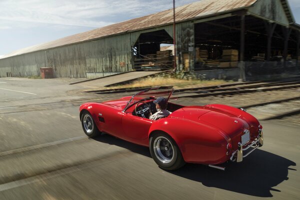 Car red convertible on the background of the road