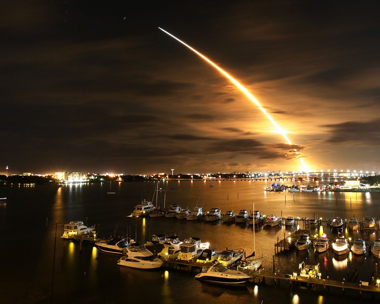 rocket launch the rise night pier lights sea water the city light yachts boats promenade sunset the sky flight the night sky the lights of the city