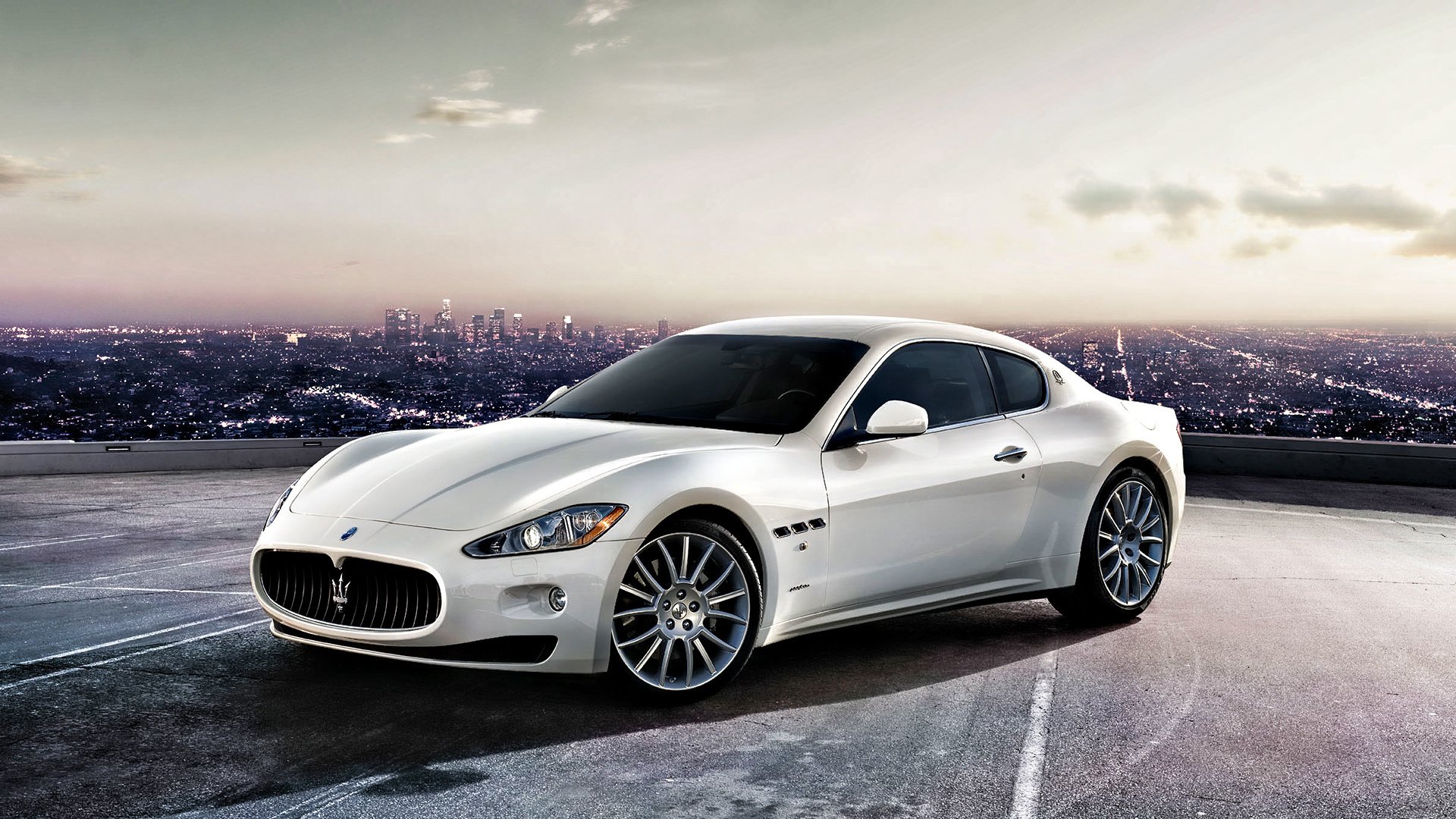 white car on the background of the city maserati height auto white the city italy sunset cars transport vehicle