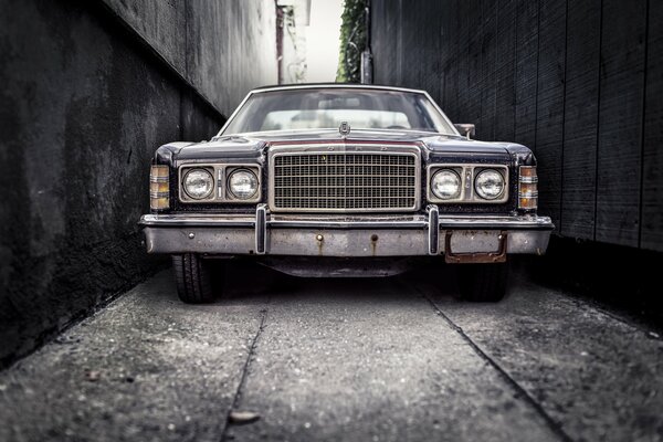 An old car in a dark alley