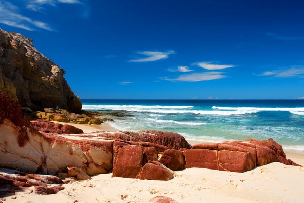 A deserted beach with a rocky shore