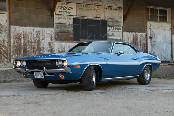 Old Dodge challenger on the background of a warehouse