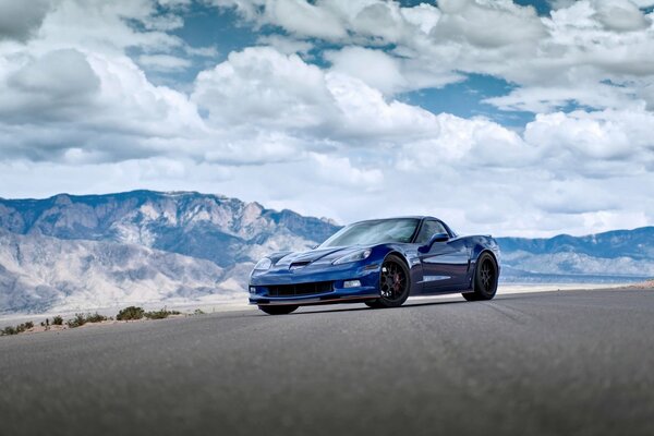 Blue chevrolet on the background of amazing mountains and clouds