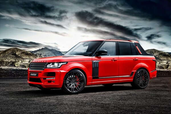 Red range rover under a leaden sky