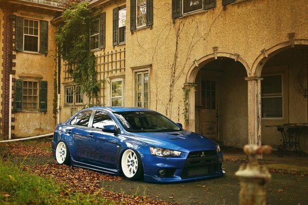 Blue mitsubishi near an old house