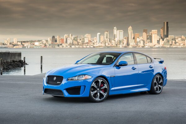 Jaguar xfr -s car is blue on a city background