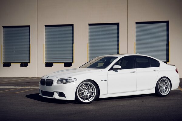 Snow - white BMW F10 5 series parked in the garage