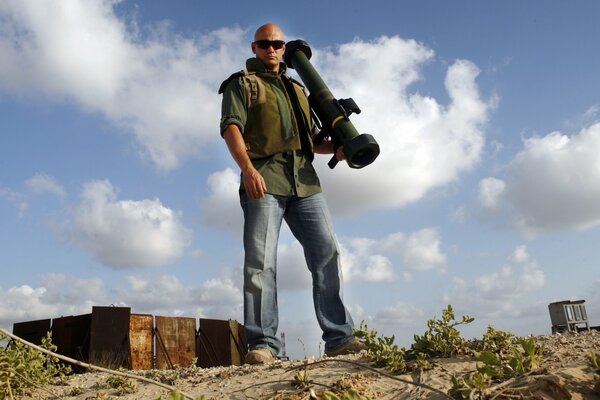 Male shooter on the background of clouds