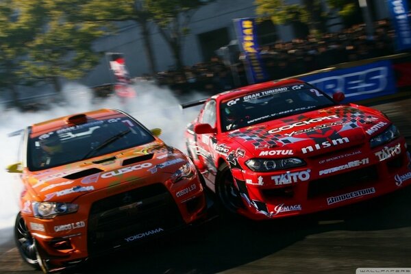 Drift of two racing cars. Smoke escapes