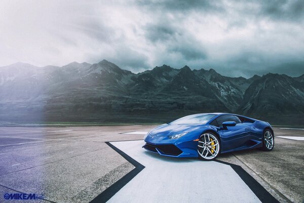 Blue Lamborghini on the background of the rocky mountains