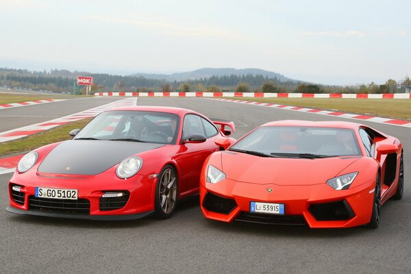 Two red Porsche, Lamborghini cars