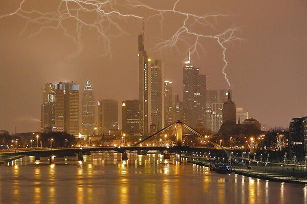 A night city illuminated by a flash of lightning