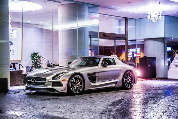 Silver Mercedes-benz amg near a modern building