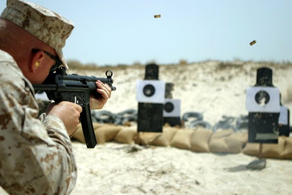 A soldier aims at a target on a shooting field