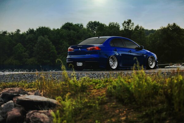 Blue Mitsubishi lancer in nature