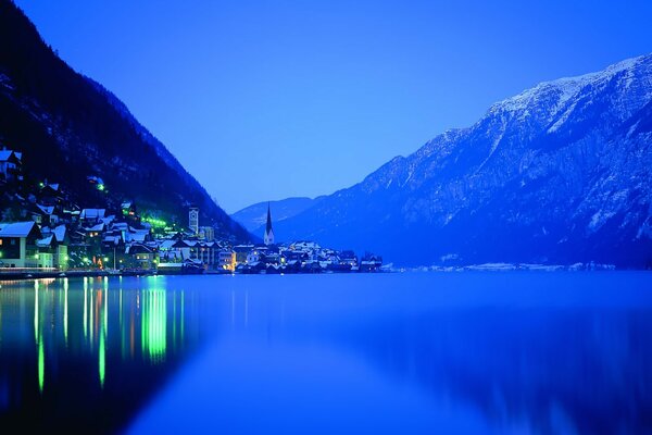 Night city. Lake. Mountains