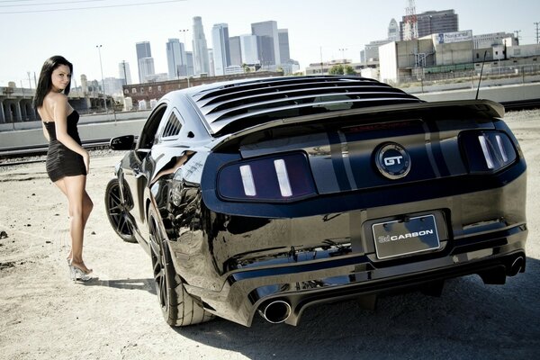 Carbon Ford mustang and a beautiful girl