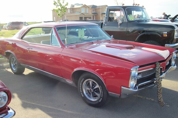 Rare red Pontiac in the parking lot