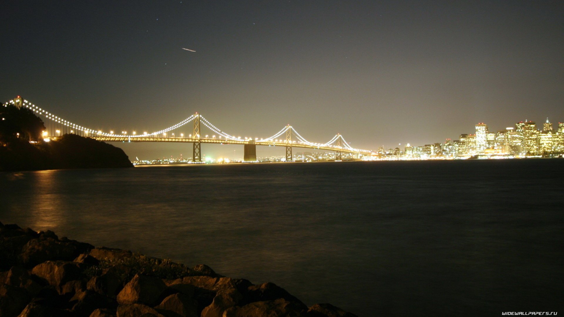 the city night bridge lights river the sky stars surface calm the night sky the lights of the city