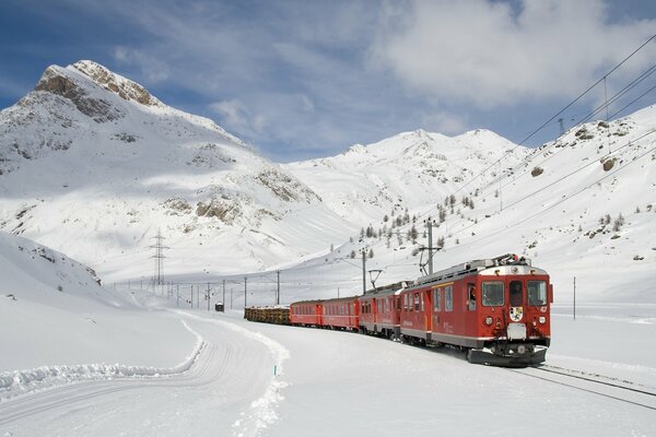 Red train on the background of snow-covered glaciers