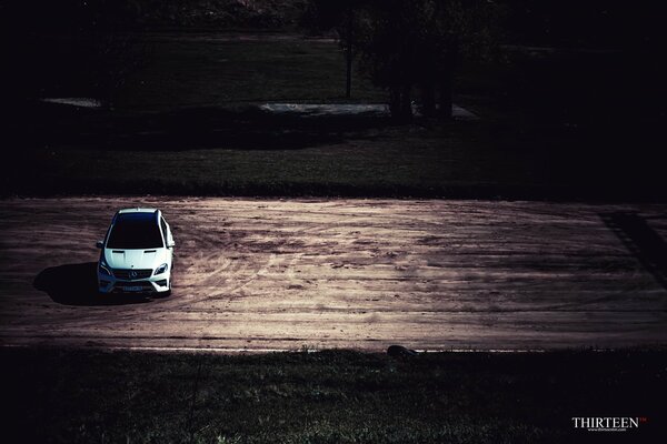 Author s photo of a snow-white Mercedes-Benz car standing alone on the road