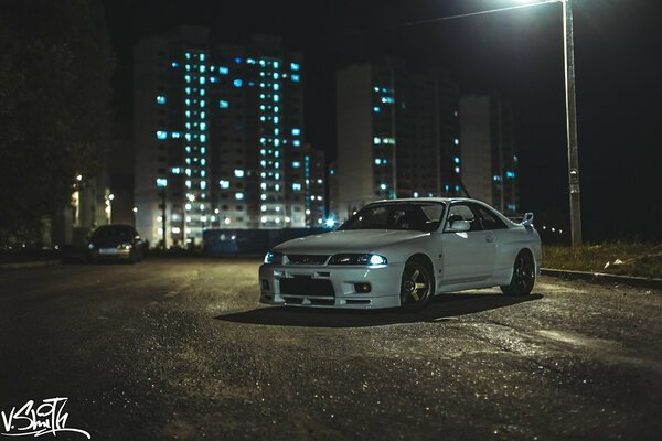 Nissan stands in the parking lot at night