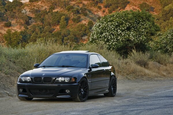 Black bmw m3 on the background of nature