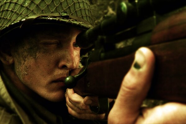 Private Ryan looks through the scope very courageously