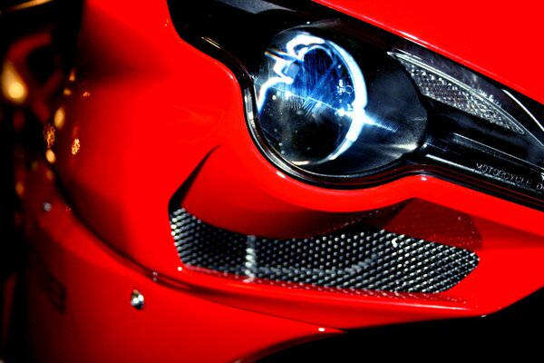 Headlights of a red sports car