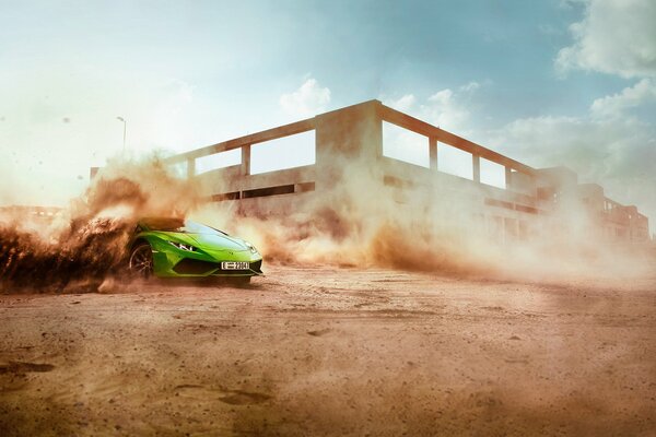 Green supercar performs a skid on a sandy road