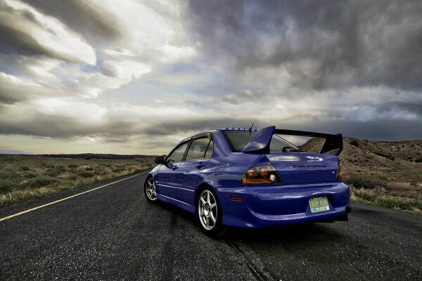 The purple car is on the evening road