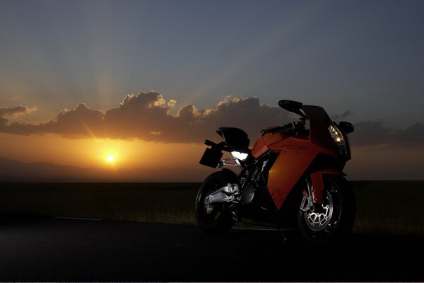 A red sports bike at sunset