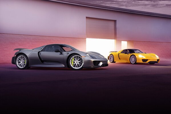 Silver and yellow Porsche spider at the entrance to the garage