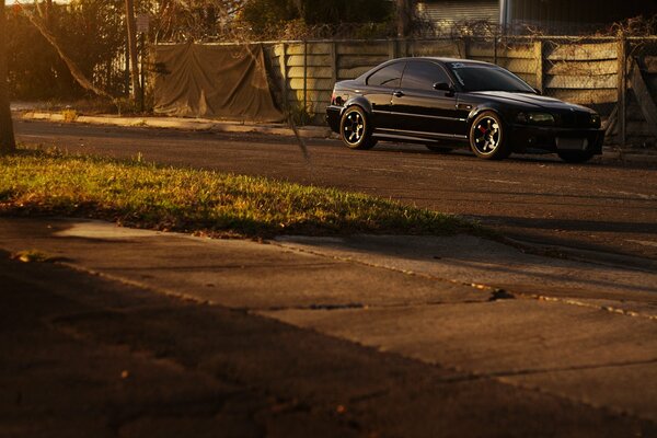 Fancy BMW at the fence with a wire