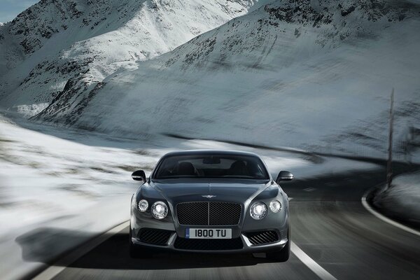 Silver Bentley continental v8 on the winter road