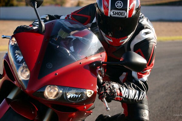 Yamaha pilot on a red moto close-up