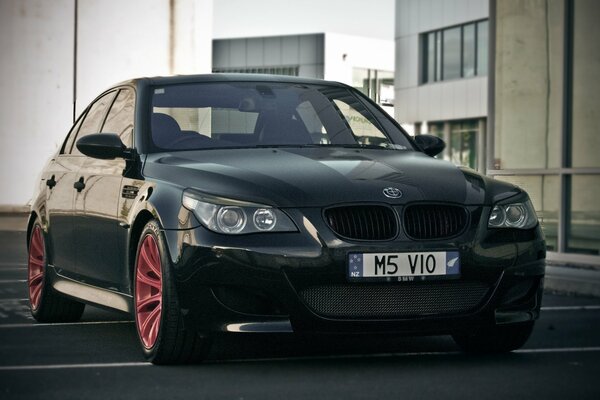 Black BMW M5 with red wheels