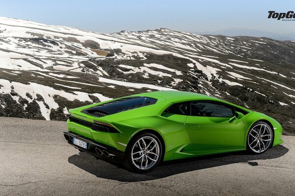 Green supercar on a mountain road