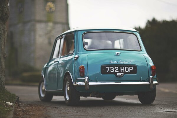 Mini car on the road near a tree