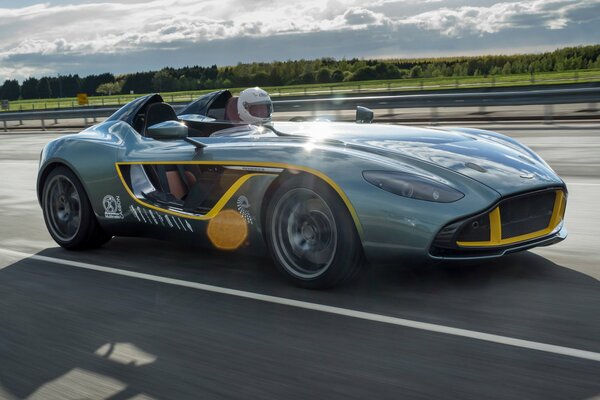 A sporty green car at speed