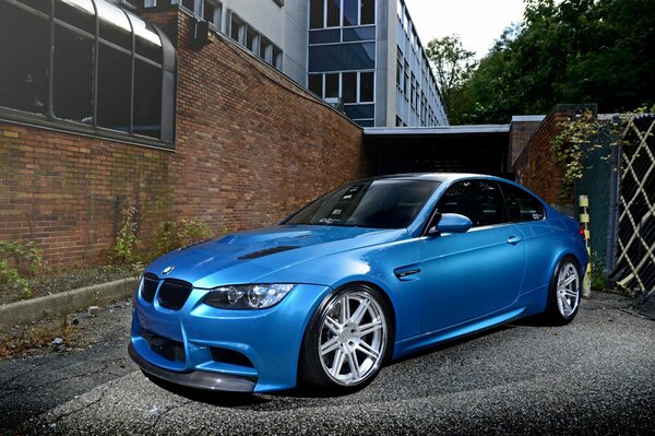 Blue BMW in the parking lot near the house