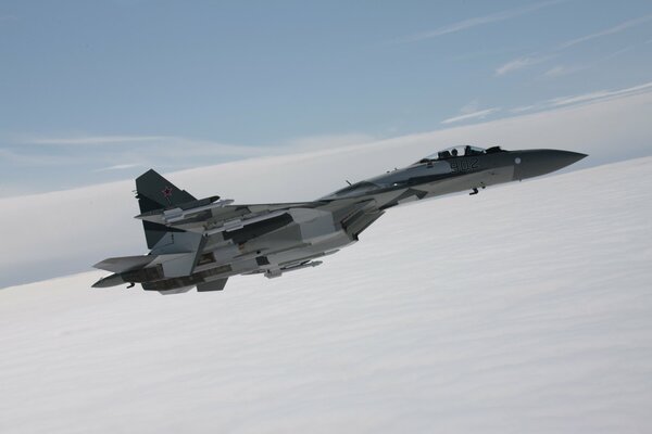 The flight of the Su 35 aircraft high above the clouds