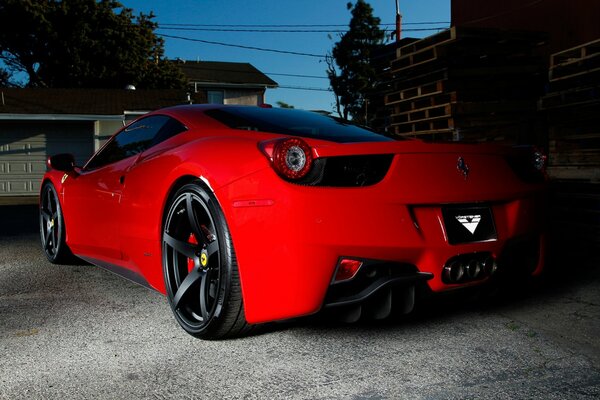 Bright red Ferrari 458 Italian against the sky