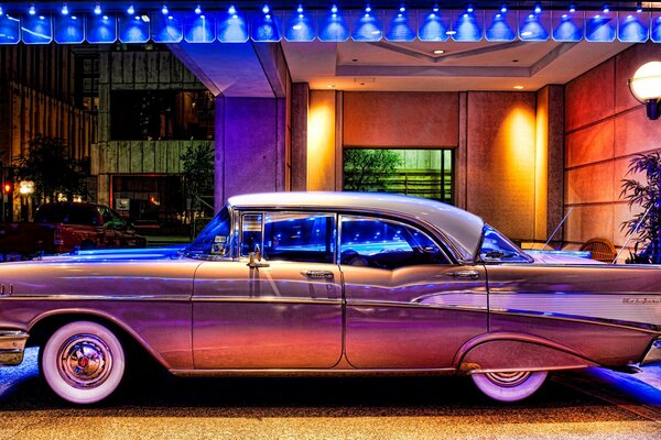 A 1957 Chevrolet on a lighted Riga street