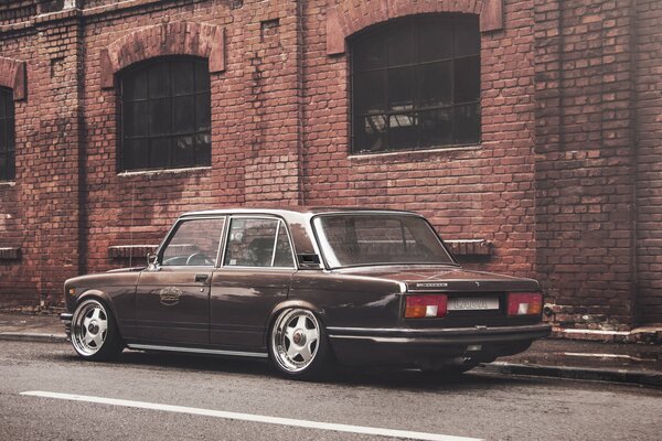 Classic Russian Zhiguli car on the background of a brick building